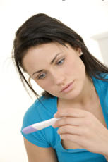 Lady looking at pregnancy test